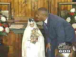 Pastor Gino Jennings and statue of Mary, sorry Saint Therese of the Child Jesus